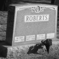 Black and white photograph of the Roberts family headstone bearing the names Munro, Clementine, and Peter.